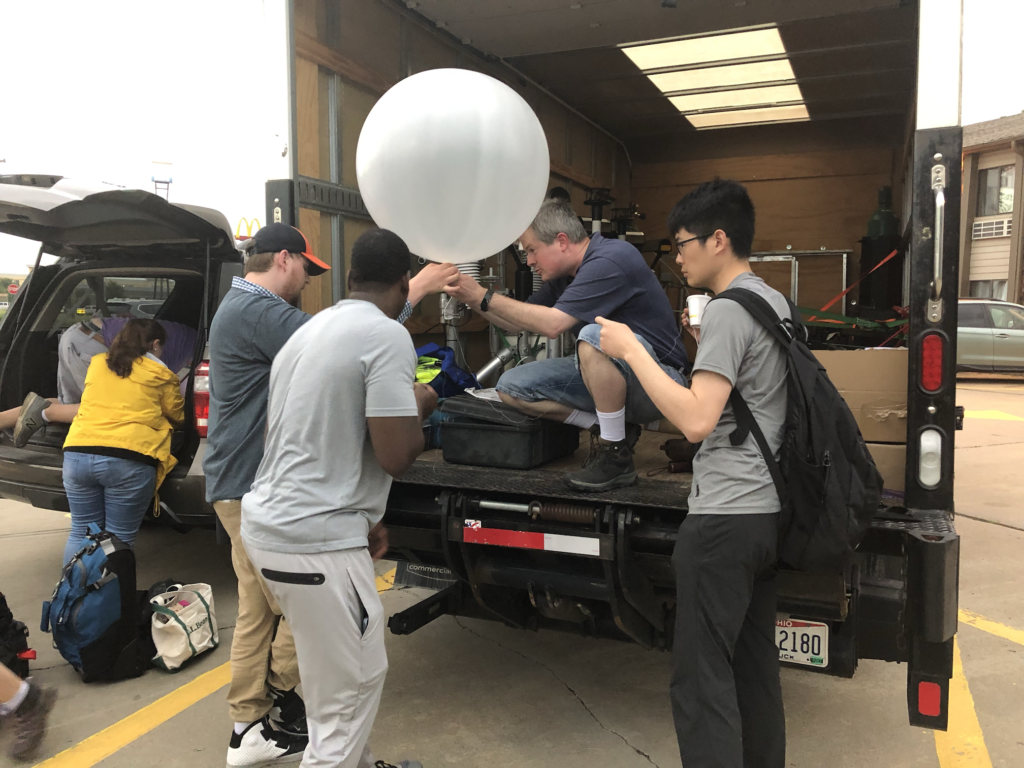 A group of people with a balloon