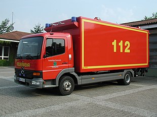 Red fire truck with 1-1-2 painted in yellow on its side