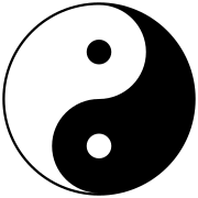 Symbol of yin and yang. It has a circular shape split into two swirling halves. One half is black with a white dot inside. The other half is white with a black dot inside.