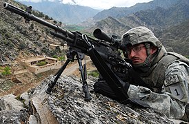 A U.S. soldier scans for activity during a combat patrol in Afghanistan, 2009.