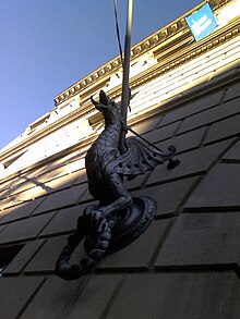 A "guard dragon" sculpture at the Liberal Arts and Policy building watches the southern entrance.