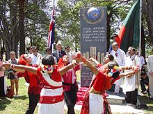 Outdoor ceremony, with girls in red-and-white costumes dancing