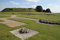 The present ruins: the exposed foundations of the cathedral in the foreground and the Norman central motte behind