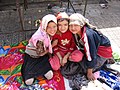 Three Uyghur girls at a Sunday market in Khotan