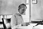 beautiful human computer sitting at her desk with pen in hand