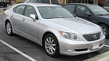 Front quarter view of a sedan parked on a street.