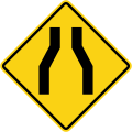 Road narrows on both sides