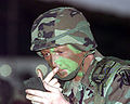 A soldier with a painted face for camouflage