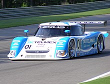 Forward angle view of a racecar on a track; the car is labeled '01', 'Lexus', and 'Telmex'.