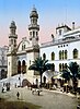 Painting of a stone building with two decorated minarets to either side of an ornamented portico, above a long flight of steps