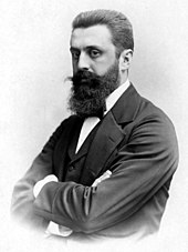 Black and white portrait of a long-bearded man.