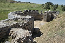 Apse of the ruined Great Basilica, Antioch in Pisidia. The floor dates to late 4th century, and the walls to the 5th or 6th century. The building has a semi-circular interior and a polygonal exterior.