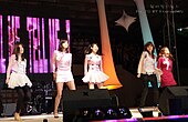 Wonder Girls dancing onstage in pink colored clothing