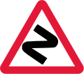 Series of bends ahead (1965–1975). This sign is rarely still used today (for sharp/dangerous bends)