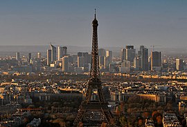 The Eiffel Tower (foreground) and the skyscrapers of the La Défense business district (background).