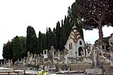 Headstones in Grand Jas Cemetery with a view of the von Derwies' chapel