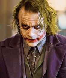 Close-up of Heath Ledger as the Joker in The Dark Knight, showcasing his makeup and Glasgow smile.