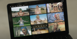 A still of the music video for Gwen Stefani's 2020 single "Let Me Reintroduce Myself", displaying a laptop broadcasting a Zoom call with nine different versions of the singer.