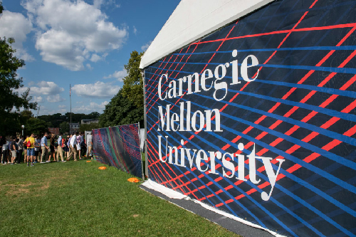 Tent at orientation and students lining up for a session