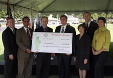 Recipients and officials holding presentation check. Click for larger image.