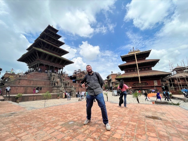 Student posing in front of building