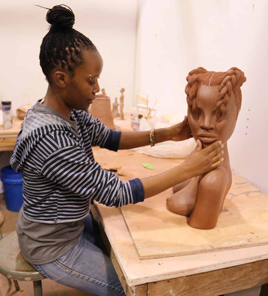 A woman works on her ceramics project