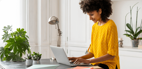 A young women uses her laptop in her home office