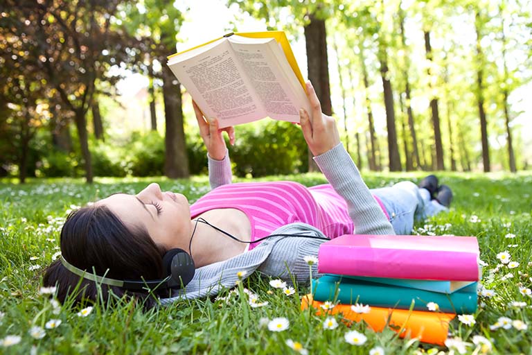 Girl reading on grass