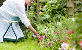 gardener kneeling on adaptive gardening stool