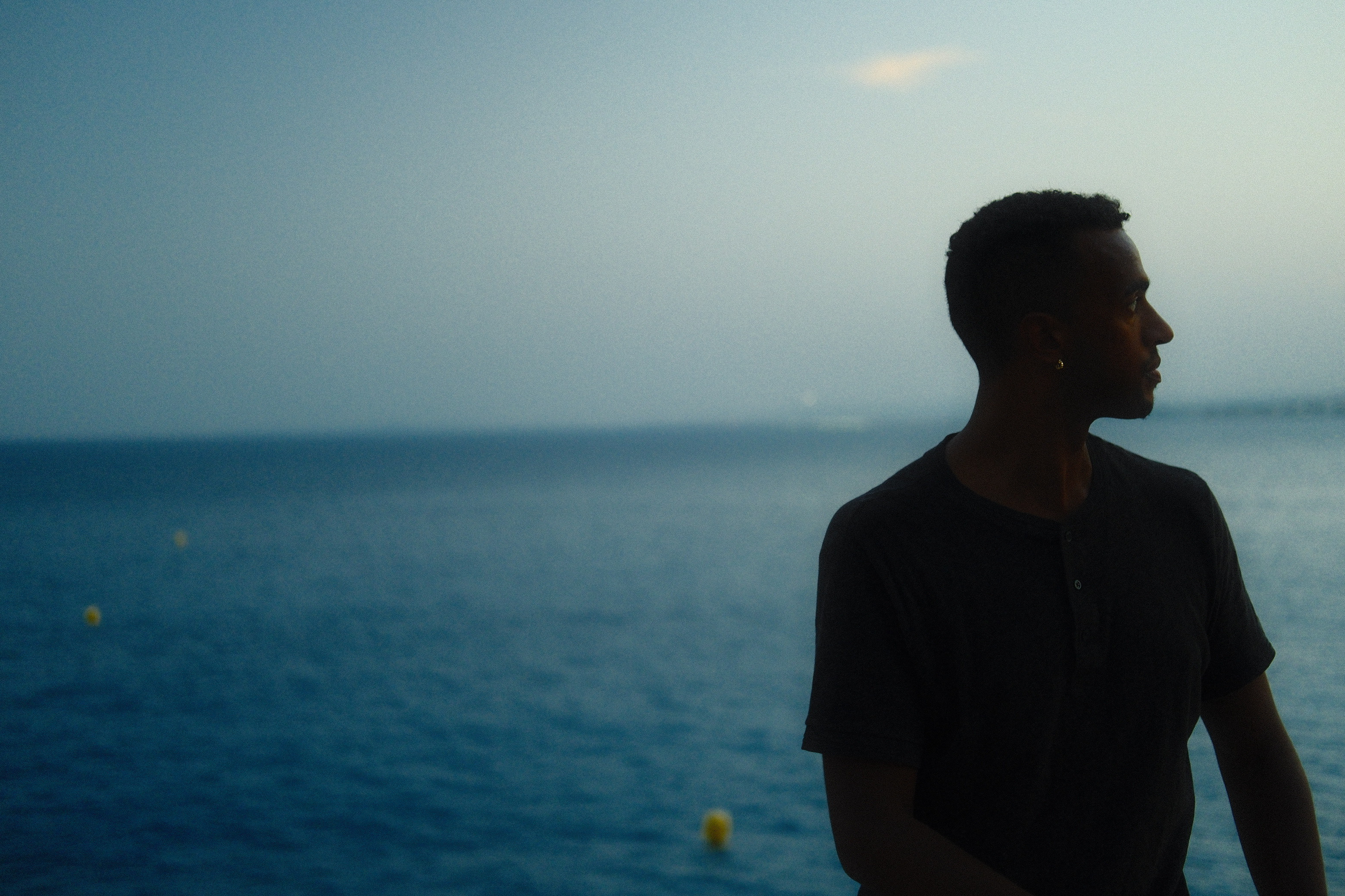 Silhouette of a man in front of the ocean