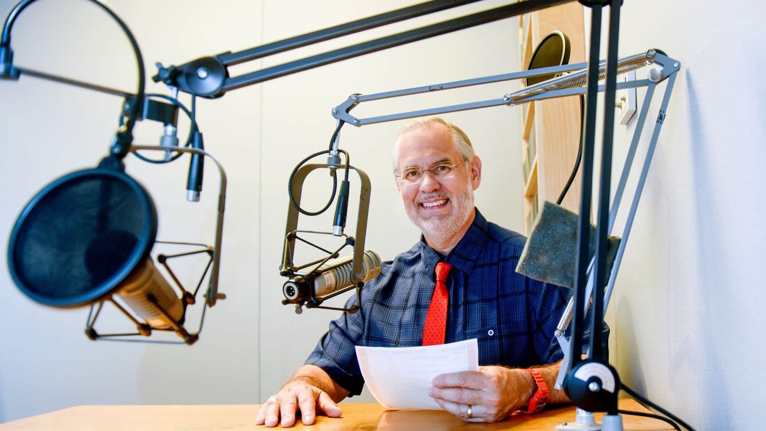 NC State College of Agriculture and Life Sciences professor Dr. Mike Walden working in a recording studio.