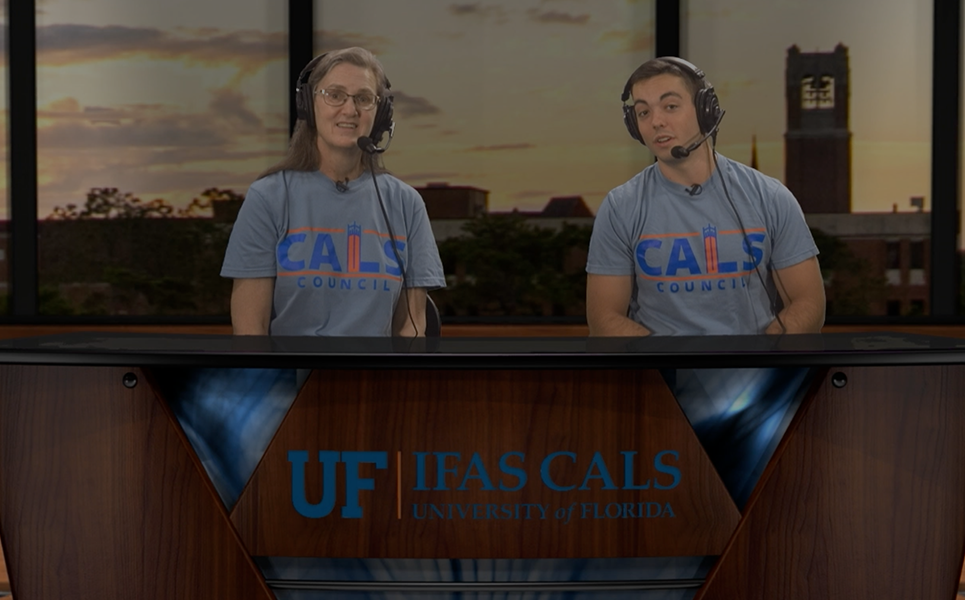 CALS dean and student sit behind a news desk with microphone head sets on.