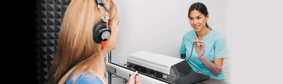 audiologist testing someone's hearing