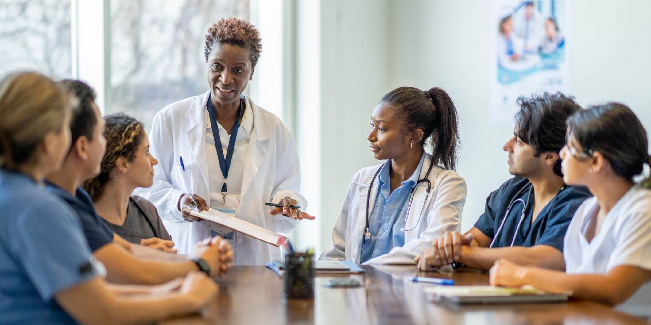 Medical students sitting around a table with professor