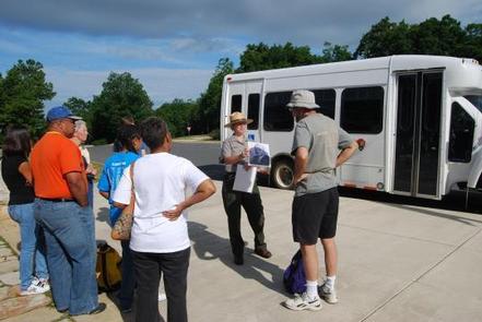 Rapidan Camp Tour bus, with people waiting to boardMeet the ranger at Byrd Visitor Center