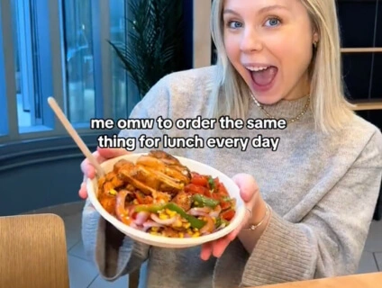 Woman holding a plate of food from Just Salad