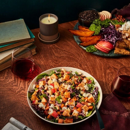 Wooden table with a salad and drinks