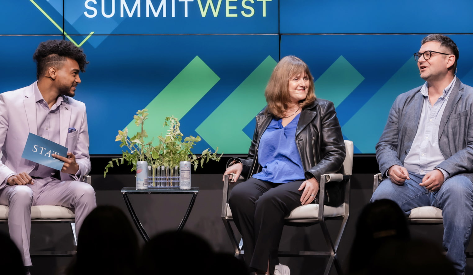 Patricia Brennan and Theofanis Karaletsos are seated on a panel discussing AI.