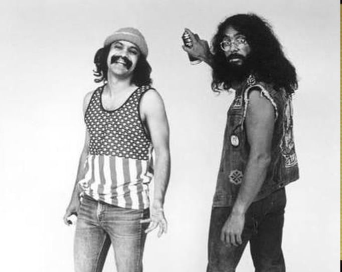 Black and white photo of Cheech and Chong from the 70s. Cheech laughs, and Tommy holds a can of spray paint looking confused.