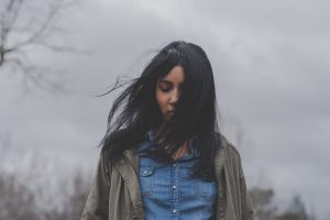 Healing bible verses- a woman looking down while the wind blew her hair