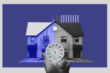 Image of a hand holding a thermometer in front of a house with a white roof on the left side. There are heat lines coming off of the black roof side.