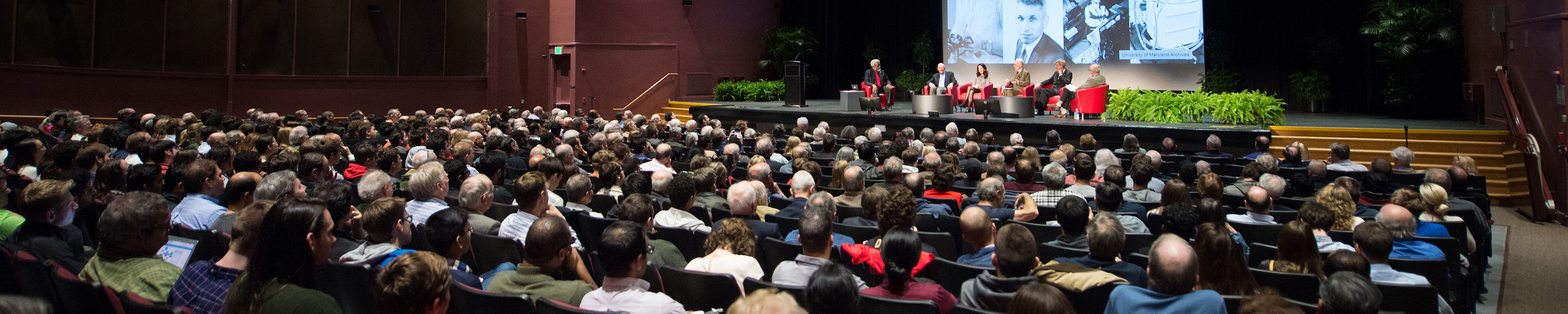 A large audience and a panel of experts at Gravitational Waves event.