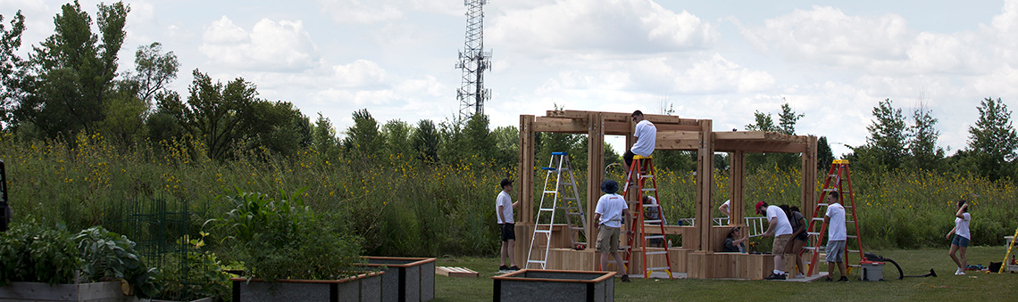 students working together outside by prairie