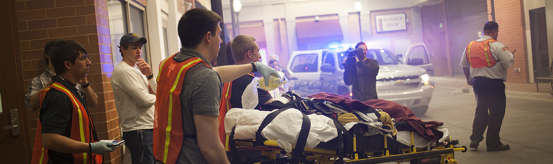 paramedic students practicing simulation on street scene