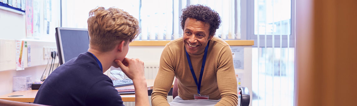 Counselor talking to a student in an office