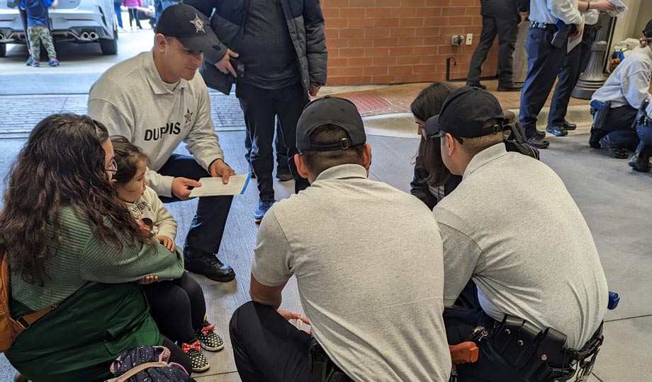 Cops and student reading in the HEC Street Scene