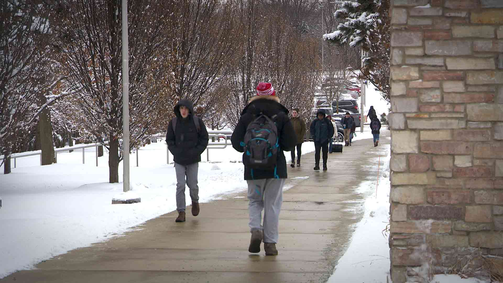 students walking on campus in snow