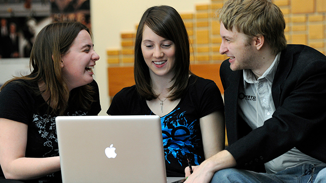 three students on computer