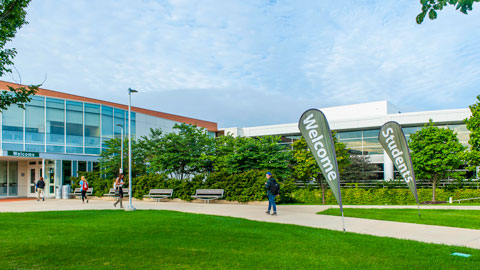 Entrance of campus with welcome flags