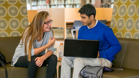 Two students working together on a computer